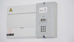 Electrical meter and fuse box on a white wall in Cape Town, South Africa, for energy monitoring or billing.