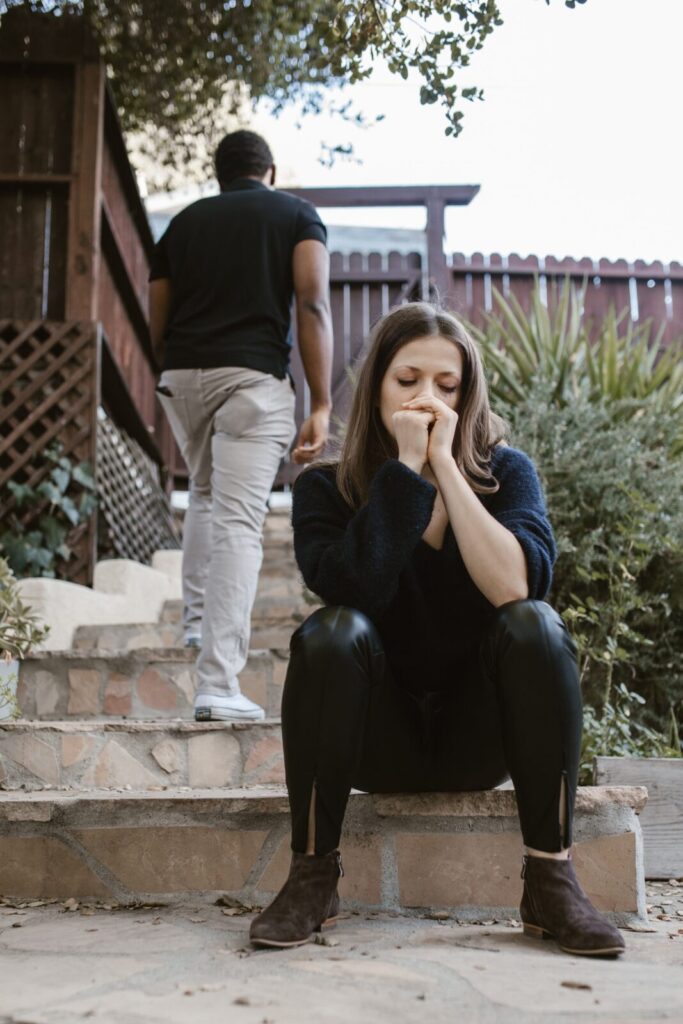 Woman on steps as her partner walks away